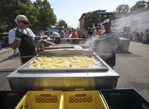 Jack Zacharias (left) and Bill Zacharias stir up the corn cobs in a vat of boiling water. Established in 1967, the Morden Corn and Apple Festival is the town's chief attraction, and is always held in the fourth week of August. Friday, August 23, 2013. (JESSICA BURTNICK/WINNIPEG FREE PRESS)