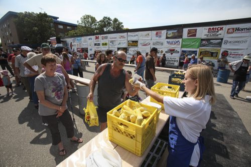 Freshly boiled corn is served to the eager festival-goers. Established in 1967, the Morden Corn and Apple Festival is the town's chief attraction, and is always held in the fourth week of August. Friday, August 23, 2013. (JESSICA BURTNICK/WINNIPEG FREE PRESS)