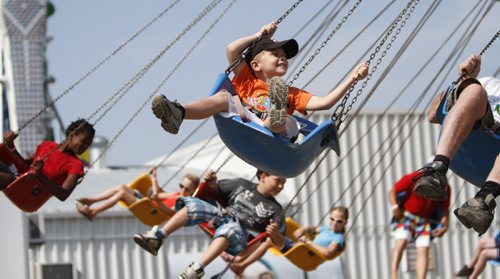 Six-year-old Austin West of Calgary is all smiles on the midway swing ride. Established in 1967, the Morden Corn and Apple Festival is the town's chief attraction, and is always held in the fourth week of August. Friday, August 23, 2013. (JESSICA BURTNICK/WINNIPEG FREE PRESS)