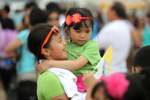 Ten year old Eloiza Cantos dances with her cousin Shanleigh Cabaguio - 6yrs while attending the Filipino Street Festival held in the parking lot of Garden City Shopping Centre Saturday.  The event runs until 9pm Saturday night. August  24,, 2013 Ruth Bonneville Winnipeg Free Press