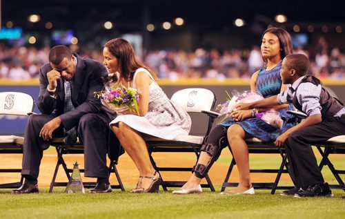 Ken Griffey Jr gets emotional and is conforted by his wife Melissa Griffey, after seeing a video message from his son Trey Griffey, Saturday night at Safeco Field in his induction to the Mariners Hall of Fame. His daughter Taryn Griffey and son Tevin Griffey can be seen on the right.  (AP Photo/Ketchikan Daily News,  Hall Anderson)