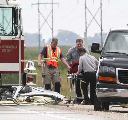 A body is removed from the scene of a crash involving two vehicles which occurred on Highway 3 about 2-kms West of Brunkild, Man. today around 4 p.m. One infant and one child were among the victims. Two people were dead at the scene, and the others transported to hospital. Saturday, August 24, 2013. (JESSICA BURTNICK/WINNIPEG FREE PRESS)
