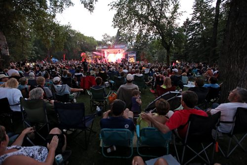 Brandon Sun 24082013 A huge crowd watches as Glass Tiger performs during a free concert in honour of Riding Mountain National Park's 80th Anniversary on Saturday evening. Fans filled the grass and the beach adjacent to Clear Lake for the concert which also included performer Jess Moskaluke. (Tim Smith/Brandon Sun)