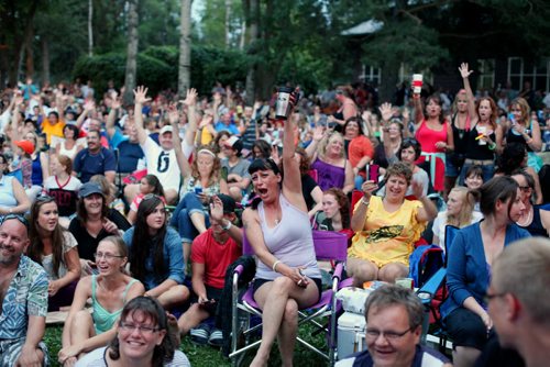 Brandon Sun 24082013 Fans cheer as Glass Tiger performs during a free concert in honour of Riding Mountain National Park's 80th Anniversary on Saturday evening. Fans filled the grass and the beach adjacent to Clear Lake for the concert which also included performer Jess Moskaluke. (Tim Smith/Brandon Sun)