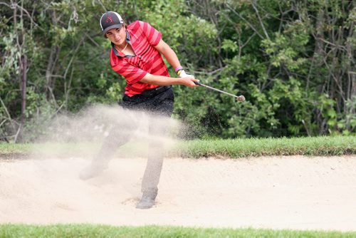 Brandon Sun 24082013 Steven Young blasts out of a sand trap while on his way to winning the junior men's championship at the Tamarack Golf Tournament at Clear Lake Golf Course on Saturday afternoon. (Tim Smith/Brandon Sun)