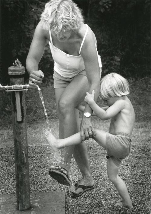 40 years of Folk Fest -- Nichloas Laporte, 4, gives his mother Mette a hand with a foot wash during the Folk Festival on a Saturday afternoon. July 9, 1983. (STU PHILLIS/WINNIPEG FREE PRESS ARCHIVES) winnipeg folk festival. fparchives