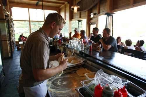 Brandon Sun Tyler Katkins, owner of the Foxtail Cafe, makes pizza dough as the cafe buzzes with diners on Saturday evening just to the south of Riding Mountain National Park on Highway 10. (Tim Smith/Brandon Sun)