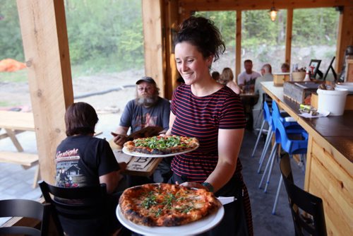 Brandon Sun Erin Grimsley serves wood-fired pizzas at the Foxtail Cafe on Saturday evening just to the south of Riding Mountain National Park on Highway 10. (Tim Smith/Brandon Sun)