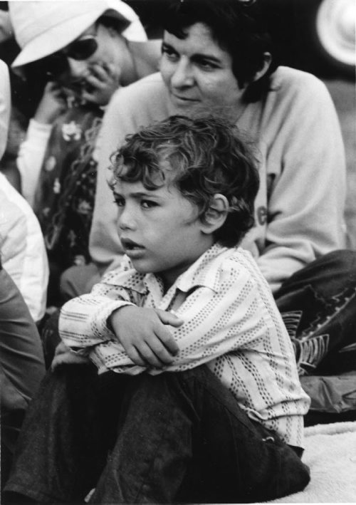 A child watches the 1976 Winnipeg Folk Festival at Birdshill Park. Dave Landy / Winnipeg Folk Festival. fparchives