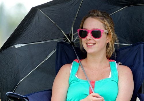 Brandon Sun 25082013 Kayla Hunter of Neepawa shades herself from the hot sun with an umbrella as she watches as Brandon Inspire takes on Winnipeg Dynamo during Manitoba Major Soccer League action at the Optimist Soccer Park on Sunday afternoon.  (Tim Smith/Brandon Sun)