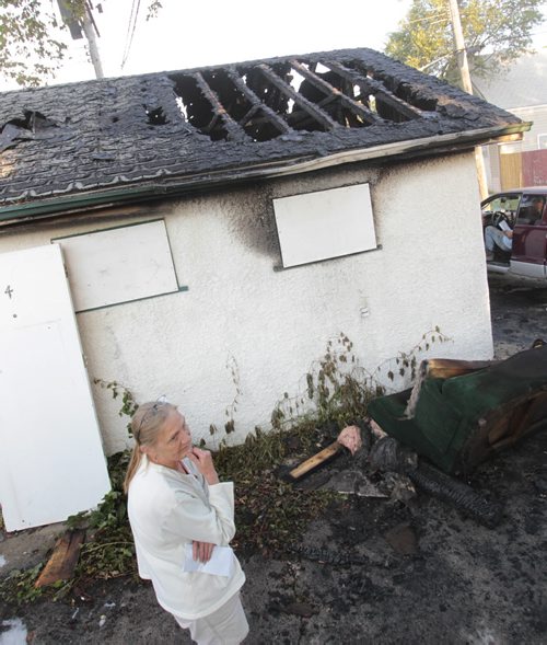 Melody Gauthier by her fire damaged garage behind her home at 422 Arlington St. Monday morning, a male tossed a bottle in the widow at 3:30 AM and the structure  went up in flames. Wayne Glowacki / Winnipeg Free Press  Aug. 26  2013