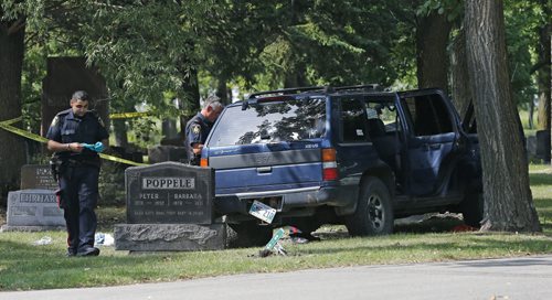 Wpg Police are investigating  a single vehicle collision inside Brookside Cemetery , a blue SUV left the roadway narrowly missing headstones and struck a tree , two people have been transported to hospital ( injuries may be serious needs to be confirmed)- happened just before 1pm Monday  KEN GIGLIOTTI / Aug 26 2013 / WINNIPEG FREE PRESS