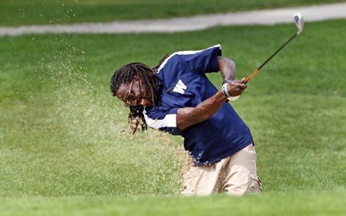 * Internal camera date not functioning today - STDUP- The Winnipeg Blue Bombers held their annual charity gold tournament at Glendale CC , with golf with the players , prizes and a dinner afterwards .In pic long slotback Kito Poblah  is pitching some sand  in style .  KEN GIGLIOTTI / Aug 26 2013 / WINNIPEG FREE PRESS