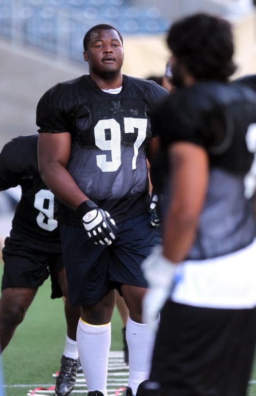 Defensive lineman David Onyemata sweats out drills at a Bison workout Monday at Investor's field. See story. August 26, 2013 - (Phil Hossack / Winnipeg Free Press)