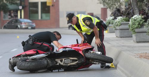 Winnipeg Police at the scene of a early morning motorcycle collision on Main St. Tuesday. The northbound lanes on Main between Market Ave. and Bannatyne Ave. are closed. Wayne Glowacki / Winnipeg Free Press Aug. 27 2013