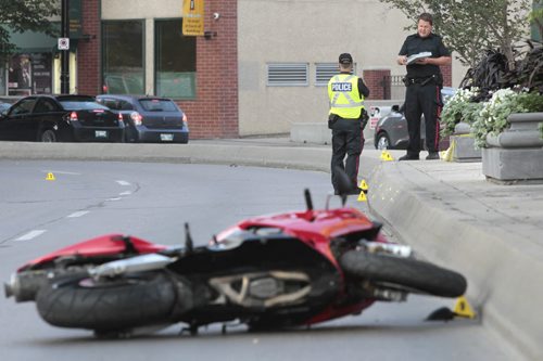 Winnipeg Police at the scene of a early morning motorcycle collision on Main St. Tuesday. The northbound lanes on Main between Market Ave. and Bannatyne Ave. are closed. Wayne Glowacki / Winnipeg Free Press Aug. 27 2013