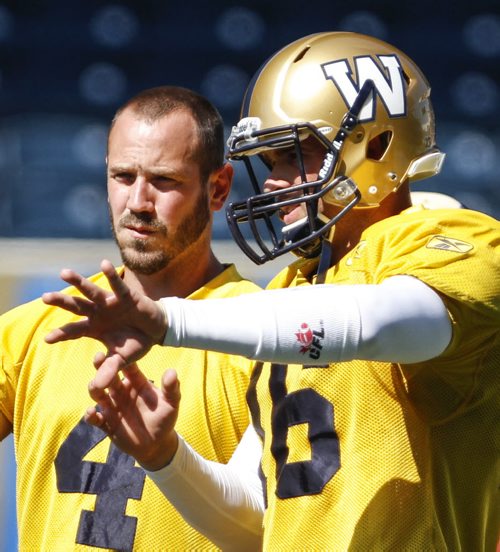 New quarterback Jason Boltus (right) talks to Buck Pearce during practice with the Winnipeg Blue Bombers at the Investors Group Field from 12-2 p.m. on Wednesday, August 28, 2013. (JESSICA BURTNICK/WINNIPEG FREE PRESS)