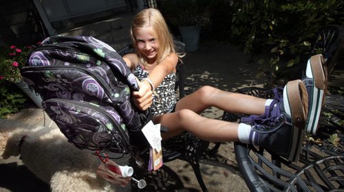 Julia Ethans shows off her new hi-tops and backpack, part of her Back-to-School package.... Geoff Kirbyson story.  August 28, 2013 - (Phil Hossack / Winnipeg Free Press)