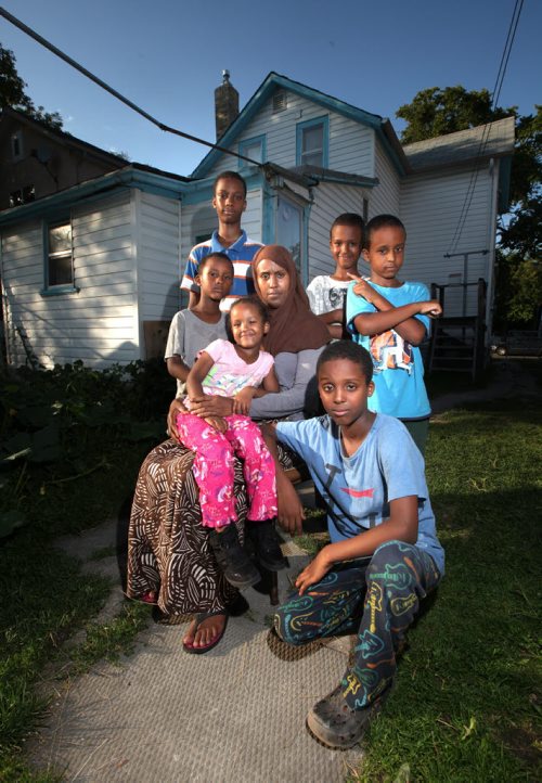Idil Timayere and her six kids*  (daughter Samiira (4) on her lap, then clockwise from left her sons, Salman, Zakeriya, Soyan, Ahmed, and Harrun (kneeng)) at their North End hot house  the woman fled Somalia, was burned out of a refugee camp in Kenya, fled to South Africa where the business she and her husband started was burned out by resentful locals. He was badly beaten and fled. She and their six kids came to Canada where she claimed refugee status. Days after being run down by a cab in Wpg and breaking several bones, a judge heard her case and has just ruled shes not a legitimate refugee. Appealing the decision will cost her $1,400 just to get the ball rolling  exactly what they get to live on in a month. For Sanders Saddest Back to School Story Ever.  August 28, 2013 - (Phil Hossack / Winnipeg Free Press)