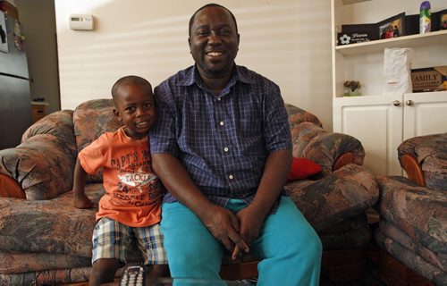 Back to School feature  ,father Bahati  Mulimbwa with his grandson Ben age 4 will be going to preschool  -story about new Canadians  going to schol for the first time in Canada Äì The Mulimbwa family - not in photo  Äì daughters Alliance age 15 , Francine 22  ,Glodi 13, ,Sylvia  age 25 ,  mother Esperance Safari Äì Oliver Sachgau story-KEN GIGLIOTTI / Aug 29 2013 / WINNIPEG FREE PRESS