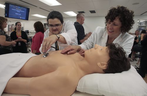 At right, Stephanie Plaitin and Jane Fedoruk both Medical Simulation Technicians with "Harvey" the cardiopulmonary patient simulator at the official opening of the expanded Simulation-based education and training lab at the U of Ms Faculty of Medicine Bannatyne Campus. The new 3,000 square foot Skills Lab will enhance teaching of clinical and procedural skills and complement the existing Clinical Learning and Simulation Facility.  ¤  see release emailed to city desk/fpphoto  Wayne Glowacki / Winnipeg Free Press Aug. 29 2013