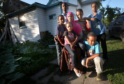 Idil Timayere and her six kids*  (daughter Samiira (4) on her lap, then clockwise from left her sons, Salman, Zakeriya, Soyan, Harrun and Ahmed (kneeling)) at their North End hot house  the woman fled Somalia, was burned out of a refugee camp in Kenya, fled to South Africa where the business she and her husband started was burned out by resentful locals. He was badly beaten and fled. She and their six kids came to Canada where she claimed refugee status. Days after being run down by a cab in Wpg and breaking several bones, a judge heard her case and has just ruled shes not a legitimate refugee. Appealing the decision will cost her $1,400 just to get the ball rolling  exactly what they get to live on in a month. For Sanders Saddest Back to School Story Ever.  August 29, 2013 - (Phil Hossack / Winnipeg Free Press)