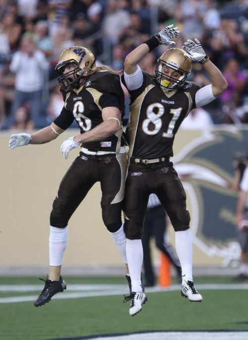 Manitoba Bisons Andrew Smith celebrates his touchdown with teammate Christian Hansen during first quarter action at their home opener against the University of Alberta Golden Bears Friday night -See story- August 30, 2013 (JOE BRYKSA / WINNIPEG FREE PRESS)
