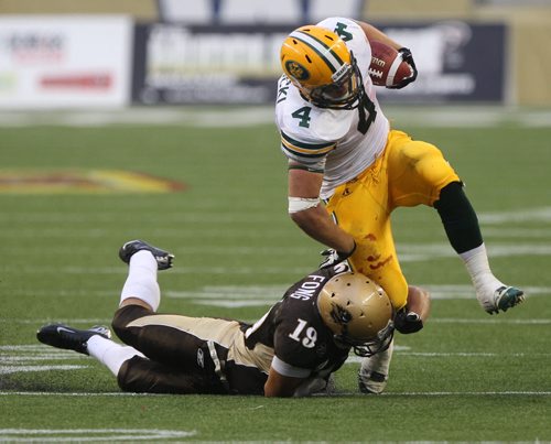 Manitoba Bisons Tyler Fong, left-bottom, hangs on to University of Alberta Golden Bears Ed Ilnicki during first half action at their home opener in their new stadium at Investors Group Field Friday night  -See story- August 30, 2013   (JOE BRYKSA / WINNIPEG FREE PRESS)