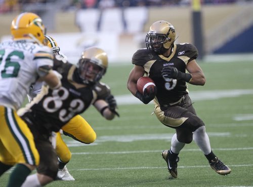 Manitoba Bisons Nic Demski, right, runs hard during play against the University of Alberta Golden Bears during first half action at their home opener in their new stadium at Investors Group Field Friday night  -See story- August 30, 2013   (JOE BRYKSA / WINNIPEG FREE PRESS)