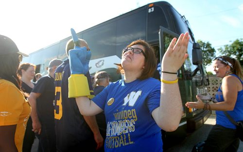 Jessica Bradley hopes for the best as she points towards heaven before she boards the All Star Tours bus with a group of faithful Winnipeg  Blue Bomber fans as they head to Regina this weekend for the Labour Day Classic game against the Saskatchewan Roughriders. Standup photo August  31,, 2013 Ruth Bonneville Winnipeg Free Press