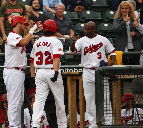 Ryan Scoma (#32) is congratulated by teammates after hitting one out of the ballpark for the first home run of the game, during the second inning. The Winnipeg Goldeyes face off tonight against the Fargo-Moorhead Redhawks at Shaw Park in Winnipeg. Saturday, August 31, 2013. (MELISSA MARTIN) (JESSICA BURTNICK/WINNIPEG FREE PRESS)