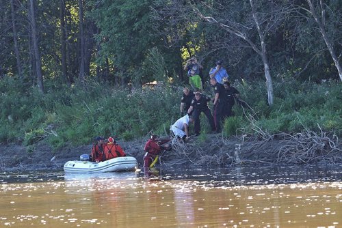 A man is pulled from the Assiniboine River Monday morning close to where Ferry Road and Portage Avenue.  130902 September 2, 2013 Mike Deal / Winnipeg Free Press