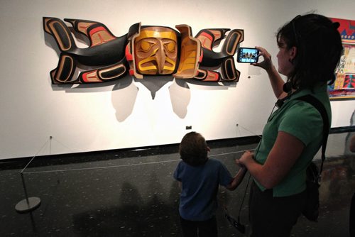 Shauna Schofield snaps a photo of a Robert Davidson sculpture with her son, Kieran, 4, as crowds filled up the rooms of the Winnipeg Art Gallery Monday on the final day of the 100 Masters Exhibition. When doors close at the end of the day the exhibit is expected to have drawn over 60,000 visitors, the WAG's largest in its 100 years.  130902 - September 02, 2013 Mike Deal / Winnipeg Free Press