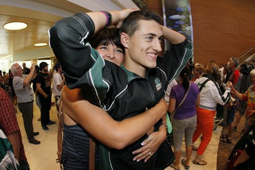 September 2, 2013 - 130902  -  Bryce Leblanc of Winnipeg's Greendell Falcons Euroteam who beat the Bristol Pride in The Gathering Bowl in Dublin, Ireland gets a hug from his mom Lorrie as the team arrives at Winnipeg's airport Monday September 2, 2013. Leblanc was also the tournament's most valuable player. John Woods / Winnipeg Free Press