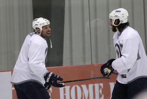 Winnipeg Jets Zach Bogosian, left, and Chris Thorburn have a laugh at practice with his team at the MTS Iceplex Tuesday-See Paul Wiecek and Gary Lawless stories- Sept 03, 2013   (JOE BRYKSA / WINNIPEG FREE PRESS)