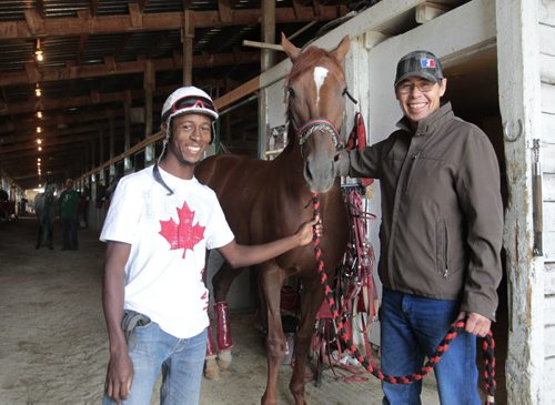 At the stables at the Assiniboine Downs, jockey Tyrone Nelson (left) and trainer Tom Gardipy Jr. with Thunderclap Newman who has won the last two marathon events in the four-race series.  Al Besson story Wayne Glowacki / Winnipeg Free Press Sept. 4 2013