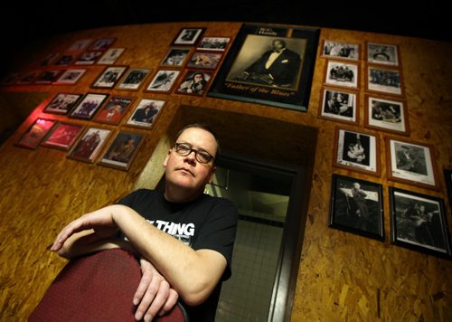 Sam Smith, talent booker at the Windsor Hotel, poses in the bar with portraits of some of the many bands from across north america who have performed there. He objects to the government's new regulation regarding foreign workers mean that any non-Canadian band that plays the venue costs him $225 per band member/crew member in a tax. See story. September 5, 2013 - (Phil Hossack / Winnipeg Free Press)