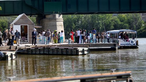 Crowds of people wait in line to board one of the Water Bus boats at the Forks dock on the Assiniboine River Thursday afternoon in balmy September weather. Standup feature photo. Sept 05,, 2013 Ruth Bonneville Winnipeg Free Press