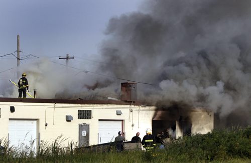 Winnipeg Fire Fighters battle a fire at the back  Metal Etch at 1143 Sanford St. that extended to the roof and interior of the business, located at the end of a string of businesses in a row under one roof.Kevin Rollason story Wayne Glowacki / Winnipeg Free Press Sept. 6 2013