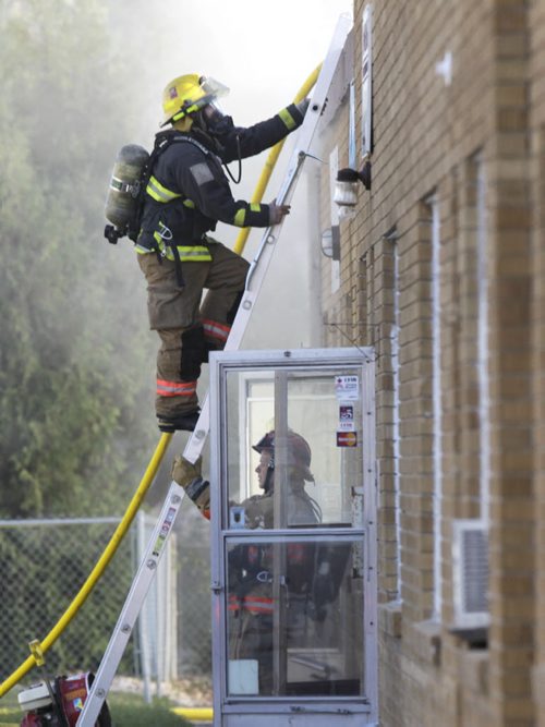 Winnipeg Fire Fighters battle a fire at  Metal Etch at 1143 Sanford St. that extended to the roof and interior of the business, located at the end of a string of businesses in a row under one roof.Kevin Rollason story Wayne Glowacki / Winnipeg Free Press Sept. 6 2013