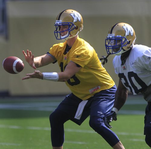 QB Justin Goltz and running back #30 Will Ford at the Winnipeg Blue Bomber practice Friday on the field at Investors Group Field preparing for the Banjo Bowl game Sunday. Ed Tait/ Paul Wiecek stories  Wayne Glowacki / Winnipeg Free Press Sept. 6 2013