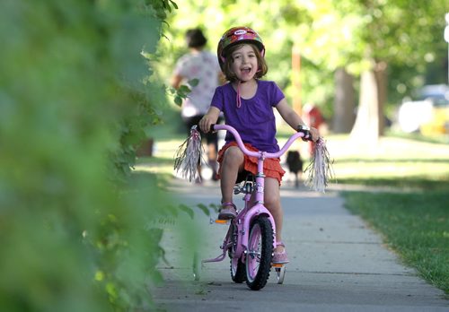 Four year old Sylvia Press enjoys a morning cycle with her mom and dog along Lanark Saturday. Standup photo Sept 07,, 2013 Ruth Bonneville Winnipeg Free Press