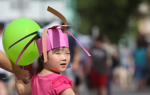 Four year old Youngeun Kim wears a hand made hat that she made at the kids play area while attending Manyfest with her mom Saturday.  See Adam Wazny's story.  Sept 07,, 2013 Ruth Bonneville Winnipeg Free Press