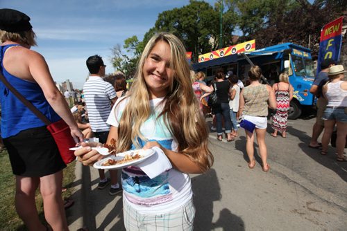 Briana Lafond enjoys some poutine with her family at Manyfest Saturday.  See Adam Wazny's story.  Sept 07,, 2013 Ruth Bonneville Winnipeg Free Press