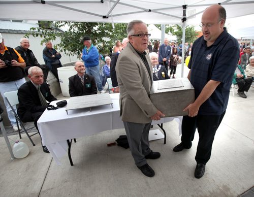 Deputy Mayor Russ Wyatt gets a little help from his father Reg (left) also a former city counsellor, lifting a time capsule into place at the grand opening of the Transcona Centennial Square. Showcased at the official opening of the public plaza will be a clock tower, fountain, heritage wall, sculptures and an amphitheatre. At the base of the pavilion stage, the Centennial Time Capsule placed to remain until 2062. The dedication will take place at 3 p.m. Entertainment will begin at 3:30 p.m. including Dean Gunnarson, the Danny Kramer Band, Aoe Adams and Genessa Ruffeski, Jason and Tom Petric and the Doreen Bisset School of Dance. Sept 9, 2013 - (Phil Hossack / Winnipeg Free Press)
