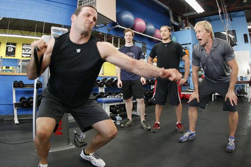 August 27, 2013 - 130827  - Pierre-Luc Labbé from the Winnipeg Blue Bombers power lifts as (L to R) Eric Nipp from the Royal Winnipeg Ballet, Ryan Garbutt from the Dallas Stars, and trainer Richard Burr keep a close eye on Labbe during a fitness competition in Burr's Winnipeg gym Tuesday, August 27, 2013. The RWB hosted a fitness competition in which a ballet dancer, a CFL player and a NHL player faced off to see who is fittest. John Woods / Winnipeg Free Press