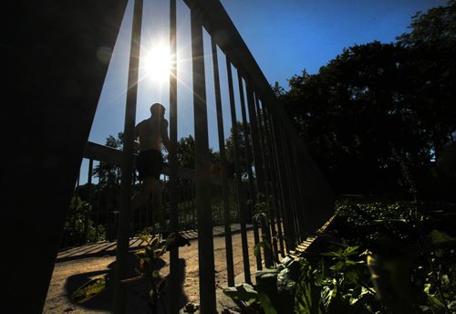 A jogger enjoys the heat of the later afternoon sun as he makes his way over the Omands Creek Bridge in Halter Park Tuesday afternoon.   Standup photo. Sept 07,, 2013 Ruth Bonneville Winnipeg Free Press