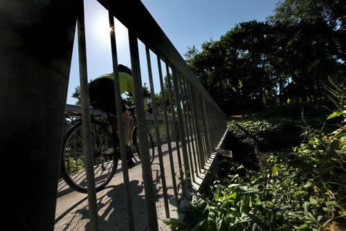 A cyclist  enjoys the later afternoon sun as they make their way over the Omands Creek Bridge in Halter Park Tuesday afternoon.   Standup photo. Sept 07,, 2013 Ruth Bonneville Winnipeg Free Press