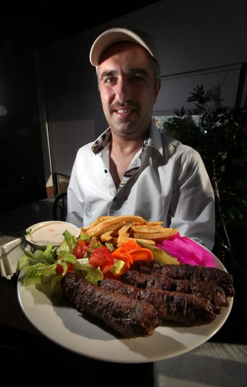 Pyramid Land - RESTAURANT REVIEW - Nezar Abdulahad (left) holds a Kabab Platter, September 10, 2013 - (Phil Hossack / Winnipeg Free Press