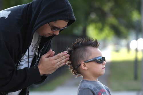 Father Jose Recabarren does some last minute adjustments on his 6 year son  Saint Recabarren mowhawk haircut before he heads to school on Burrows Ave Wednesday morning. Standup photo- Sept 11, 2013   (JOE BRYKSA / WINNIPEG FREE PRESS)